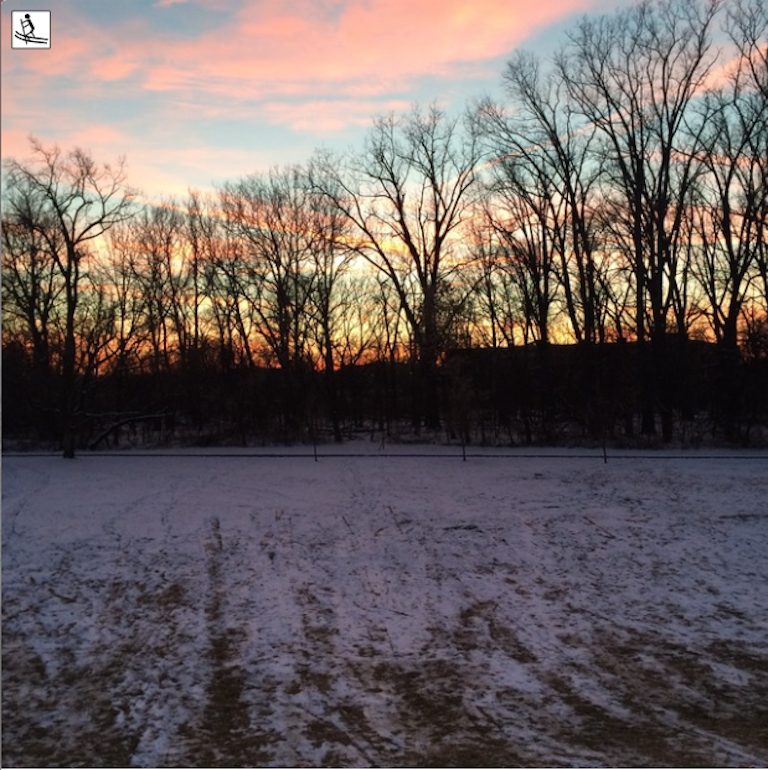 sunset over field with sparse snow